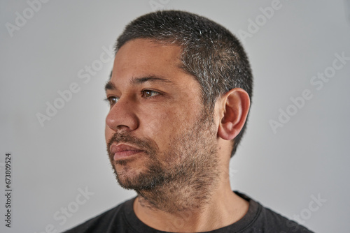 portrait of man looking to the left on neutral background