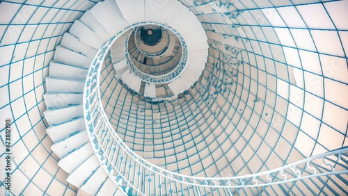 White spiral staircase with a blue tint embodies modern elegance and architectural brilliance. Its minimalistic design, abstract nature, and sleek curves make it a perfect example of contemporary art