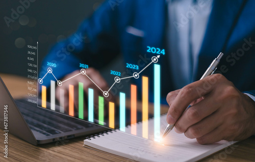 2024 business financial plan market concept, performance of profit growth on 2023 to 2024, education trend up finance on growth graph money revenue, Businessman analyzes profitability of working. photo