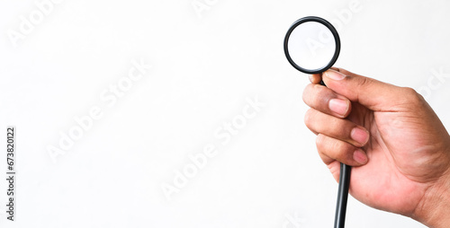 man's hand holding a stethoscope isolated white background