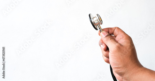 man's hand holding a stethoscope isolated white background