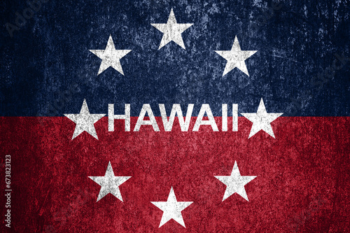 Close-up of the grunge Hawaii state flag. Dirty Hawaii state flag on a metal surface.