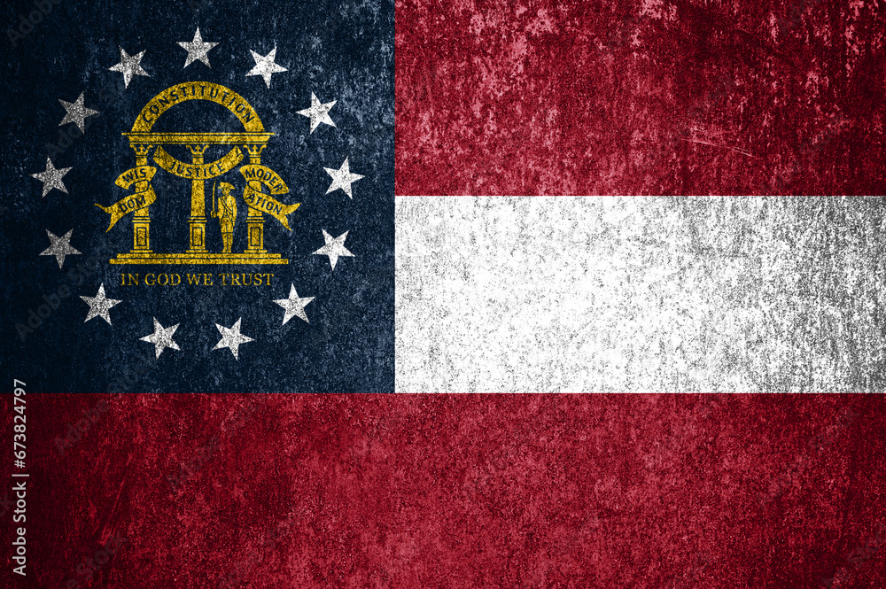 Close-up of the grunge Georgia state flag. Dirty Georgia state flag on a metal surface.