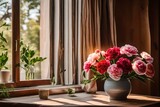 A bouquet of carnation and peony flowers, placed in a warm beige ceramic vase, on a wooden surface, near an open window.