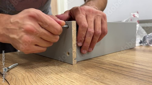 Assembling furniture with men's hands