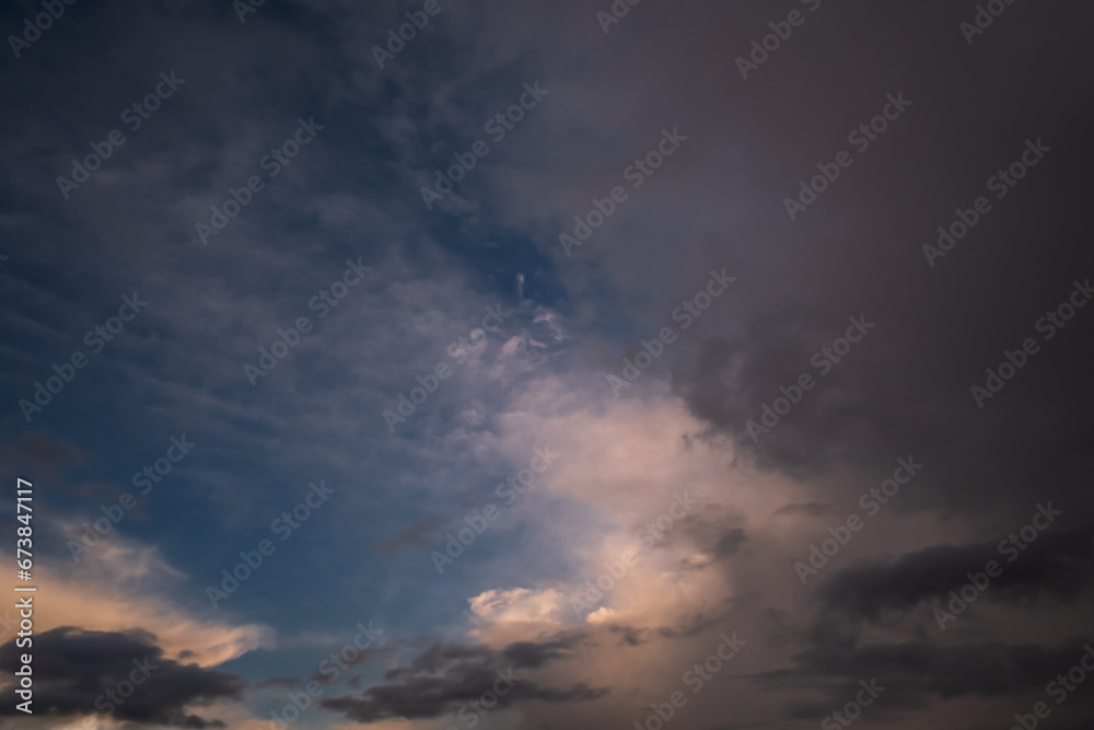 Blue violet red sunset sky background with evening curly rolling clouds may use for sky replacement