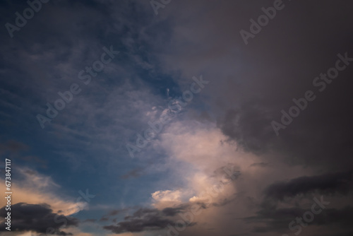 Blue violet red sunset sky background with evening curly rolling clouds may use for sky replacement