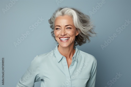 Lady with gray hair smiling at camera.