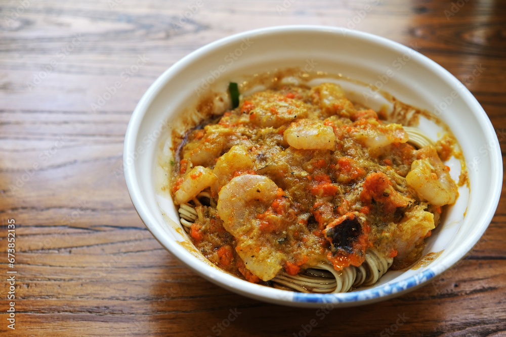 crab roe meat noodles on wooden table. Chinese seafood noodle dish crab roe meat noodles on wooden table. Chinese seafood noodle dish