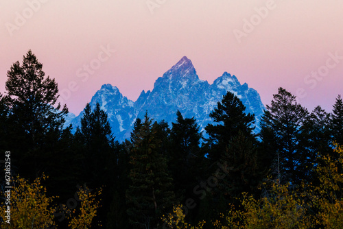 Landscape view during sunset of Middle Teton, Grand Teton and Mount Owen from the Bridger Teton National Forest in Wyoming photo