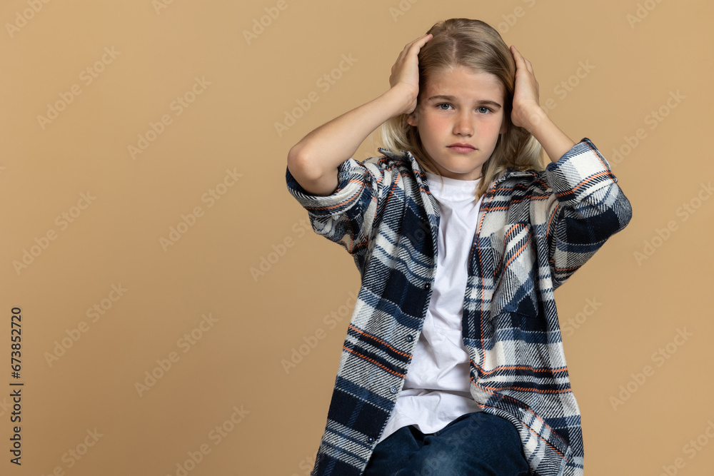 Teen girl in checkered shirt looking stressed and unhappy Teen girl in checkered shirt looking stressed and unhappy