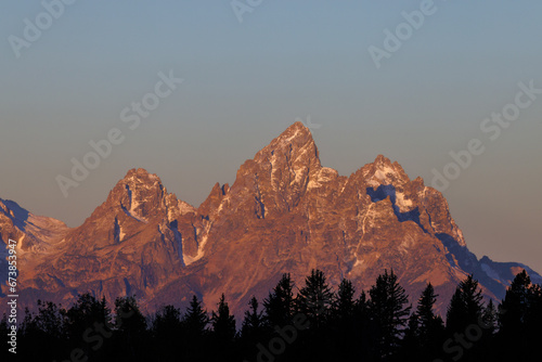 Landscape view during sunset of Middle Teton, Grand Teton and Mount Owen from the Bridger Teton National Forest in Wyoming