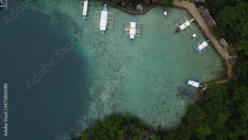 Coron's Blue Lagoon, dotted with boats, offers a tranquil vacation scene amidst crystal waters. © Alberto