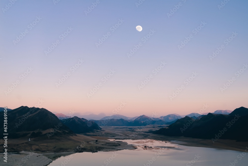 mountains surrounded by lakes and large rivers at dusk in the moonlight. mountains surrounded by lakes and large rivers at dusk in the moonlight.