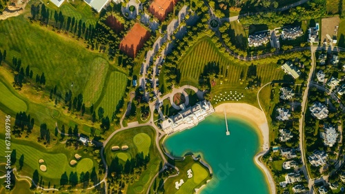 View of a peaceful and tranquil residential area featuring a large lake with lush green vegetation