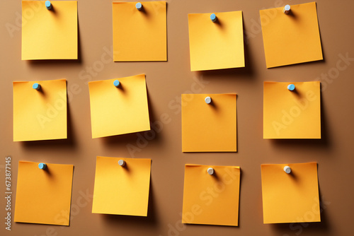 Nine post-it notes on brown background one is yellow photo