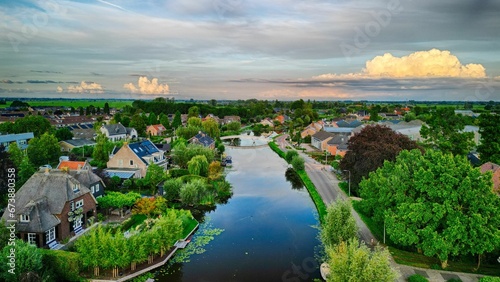 Aerial view of a river with a small town on its bank on a sunny day