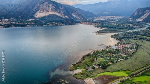 Aerial view of a small town on shore of a lake in green mountains photo