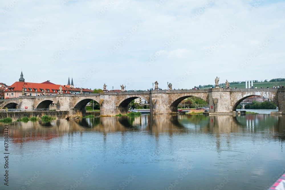 Grand river bridge spans across a wide body of water in Wurzburg, Germany