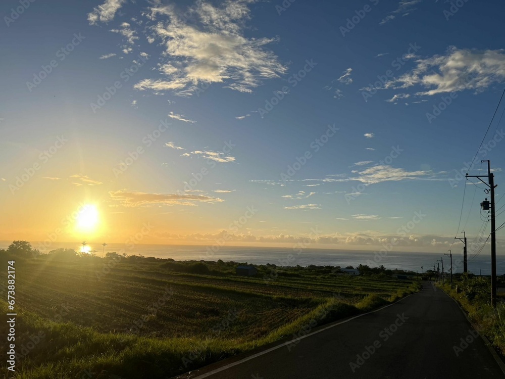 Picturesque sunrise over a calm ocean, seen from a road in Taitung, Taiwan