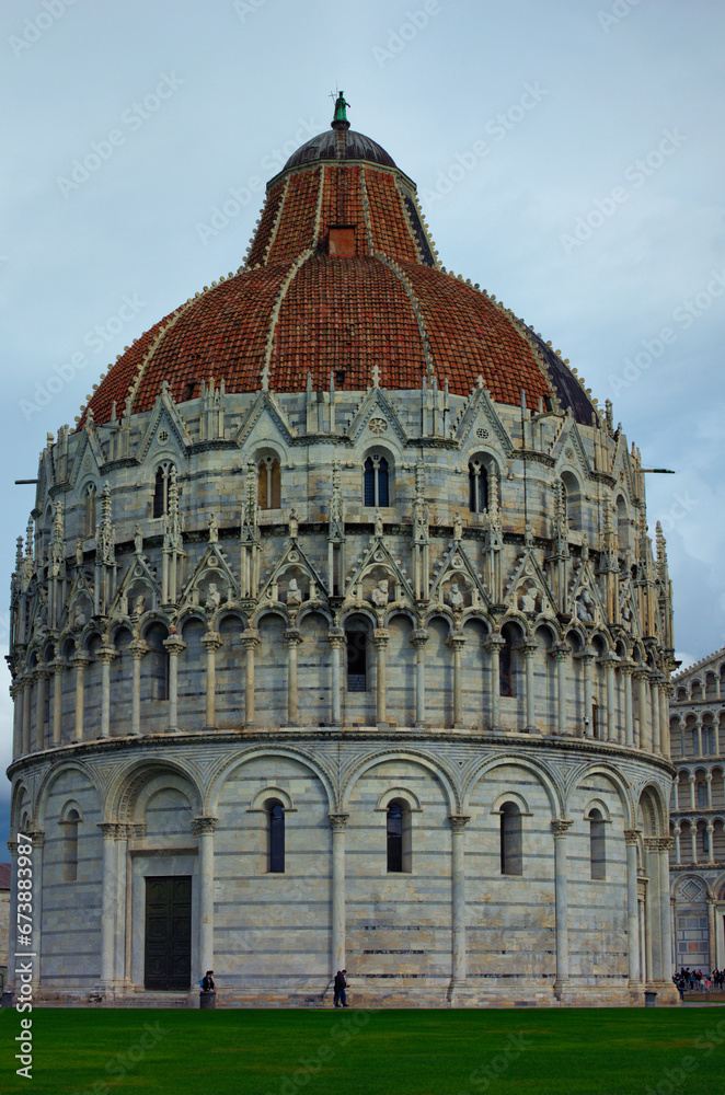 Picturesque landscape view of medieval Pisa Baptistery of St. John. It is Roman Catholic ecclesiastical building. Architectural icon of the city of Pisa, Italy. UNESCO World Heritage Site