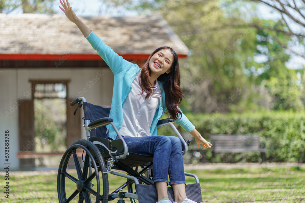 Obraz premium Young asian woman in wheelchair with positive thinking.