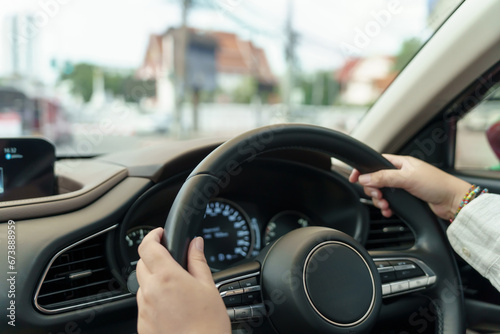 Woman driving car. girl feeling happy to drive holding steering wheel and looking on road