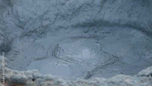 Bubbling gray mud puddles in Hverir, Iceland. Geothermal area, strong sulfur smell. Toxic gases and unstable ground. Heat causes the water to evaporate and mix with mud.