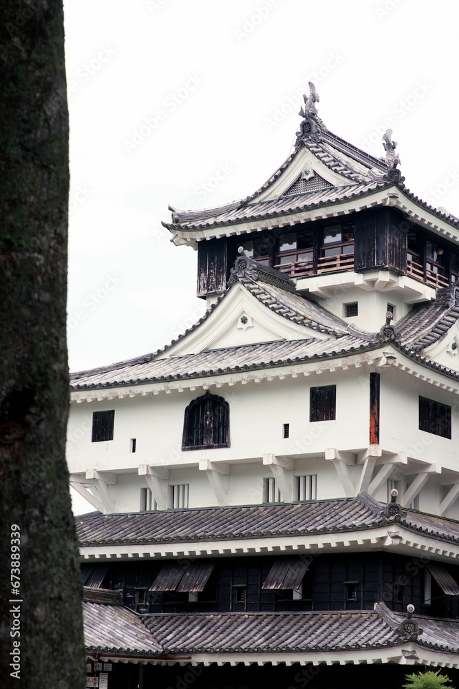 Vertical shot of a Japanese castle with contrasting white and black exterior Vertical shot of a Japanese castle with contrasting white and black exterior