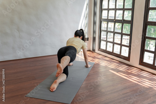 Female girl Attractive young asian woman doing stretching exercise on mat yoga Calmness and relax at gym Full body concentrated flexibility during workout