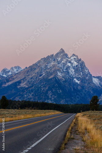 Vertical image of the Cathedral Group mountains in Grand Teton National Park with snow during fall