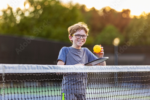 Boy on court with pickleball gear