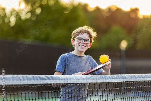 Boy on court with pickleball gear