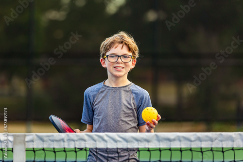 Boy on court with pickleball gear © Chad Robertson
