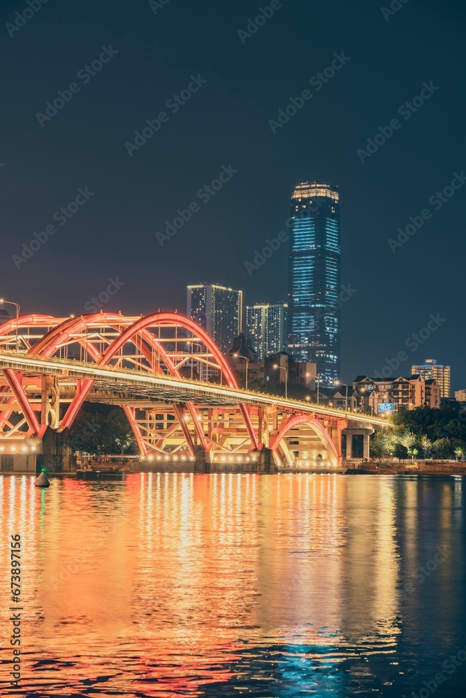 Scenic view of Wenhui Bridge with its bright night illumination. Liuzhou, China.