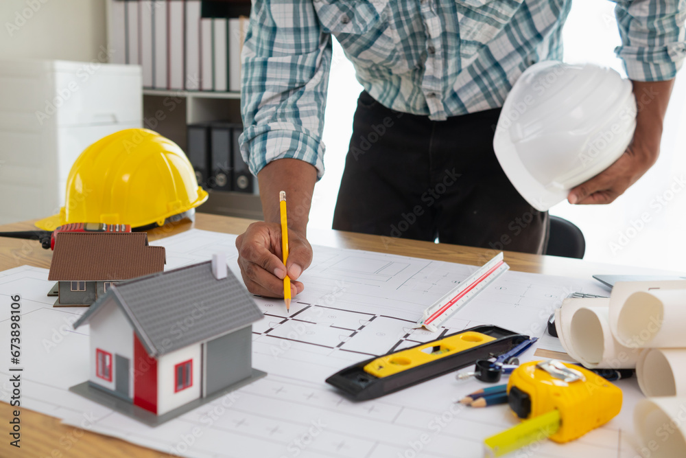 Construction engineers are checking blueprints and calculating their accuracy after receiving plans from architect in order start construction safely. Inspection Concept from construction engineering Construction engineers are checking blueprints and calculating their accuracy after receiving plans from architect in order start construction safely. Inspection Concept from construction engineering