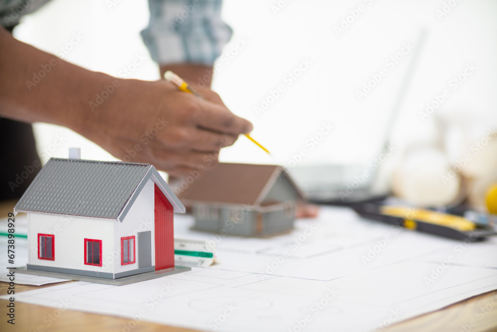 Fototapeta premium Construction engineers are checking blueprints and calculating their accuracy after receiving plans from architect in order start construction safely. Inspection Concept from construction engineering