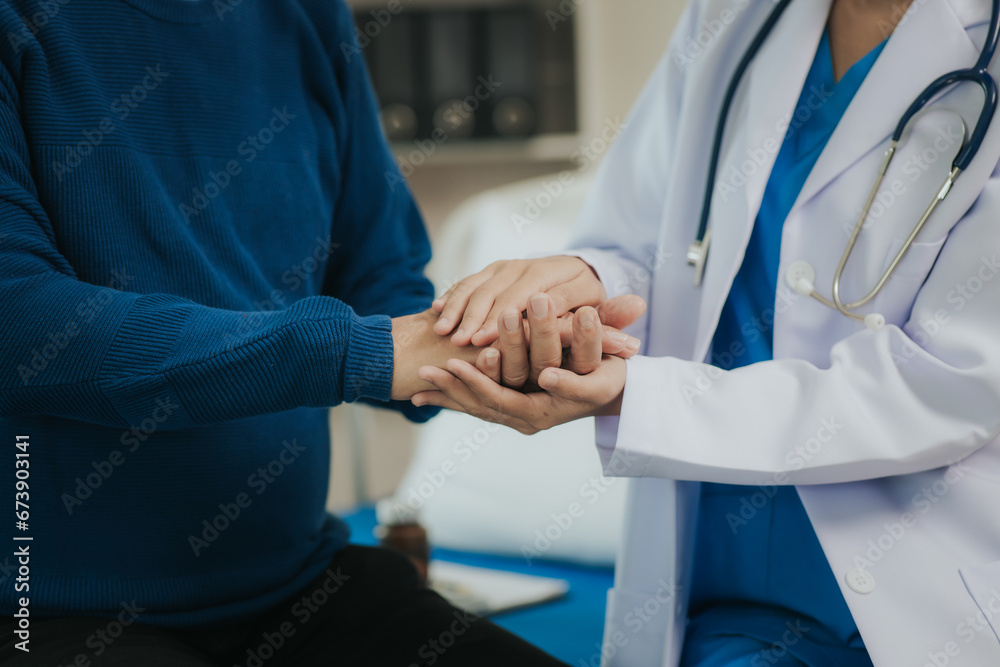 Female doctor talking taking care of her senior patient give support Doctor helping elderly patient with Alzheimer's disease A female attendant holds the hand of an elderly man Female doctor talking taking care of her senior patient give support Doctor helping elderly patient with Alzheimer's disease A female attendant holds the hand of an elderly man