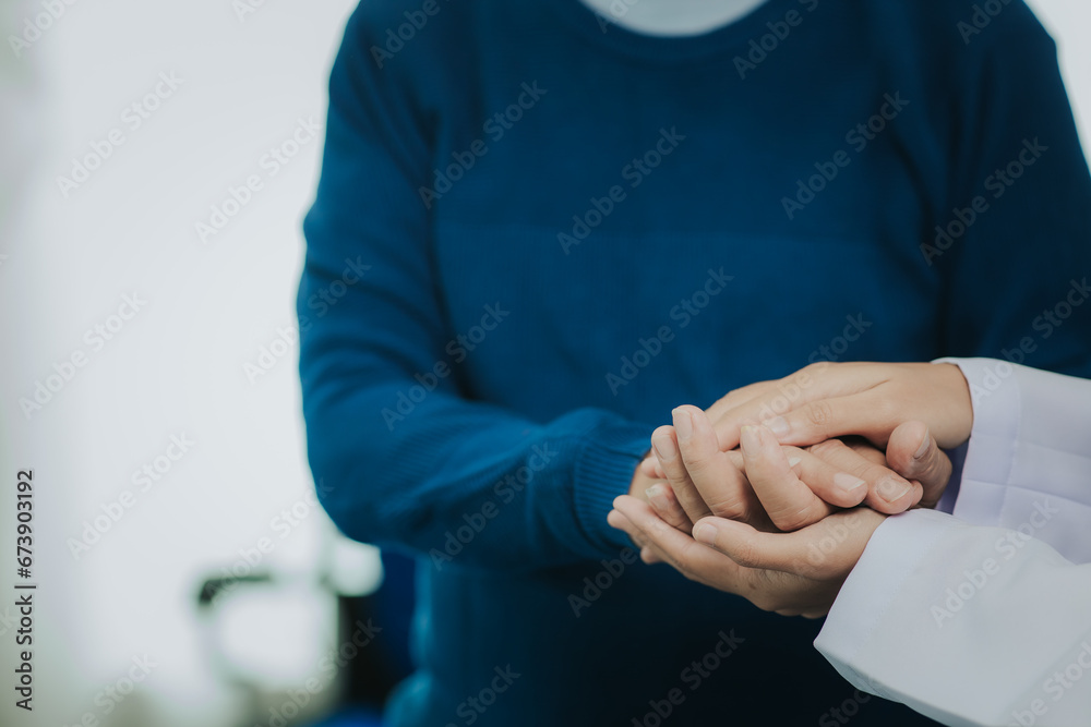 Female doctor talking taking care of her senior patient give support Doctor helping elderly patient with Alzheimer's disease A female attendant holds the hand of an elderly man Female doctor talking taking care of her senior patient give support Doctor helping elderly patient with Alzheimer's disease A female attendant holds the hand of an elderly man