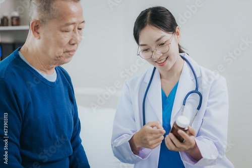 Female doctor talking taking care of her senior patient give support Doctor helping elderly patient with Alzheimer's disease A female attendant holds the hand of an elderly man