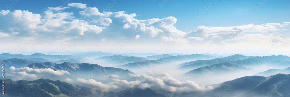 Fototapeta premium Aerial view of beautiful mountains covered with fluffy clouds on sunny day.