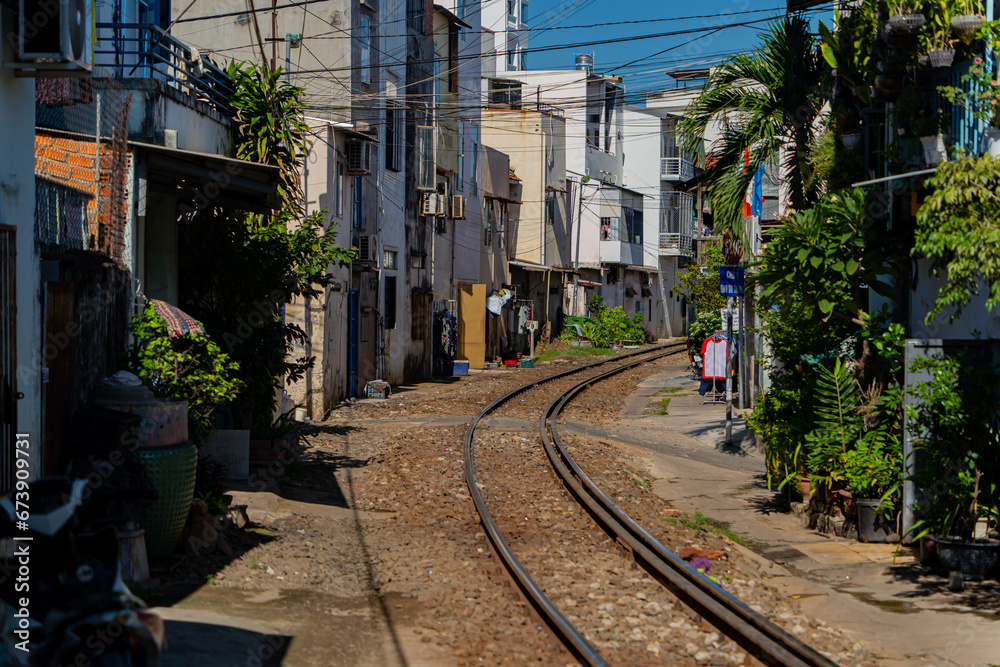 Street - railway.  A small street in Nha Trang in Vietnam with railway tracks running through the residential sector.