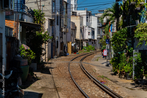 Street - railway. A small street in Nha Trang in Vietnam with railway tracks running through the residential sector.