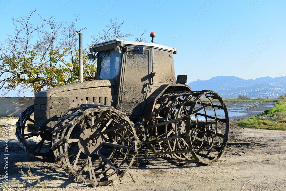 Aged tractor sits abandoned under a blue sky