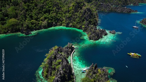 Gorgeous aerial view of the Twin lagoon with boats floating in the water, Philippines © Wirestock