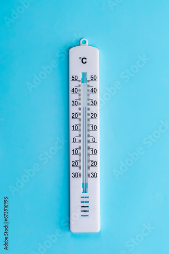 Фотография thermometer hanging on a blue background