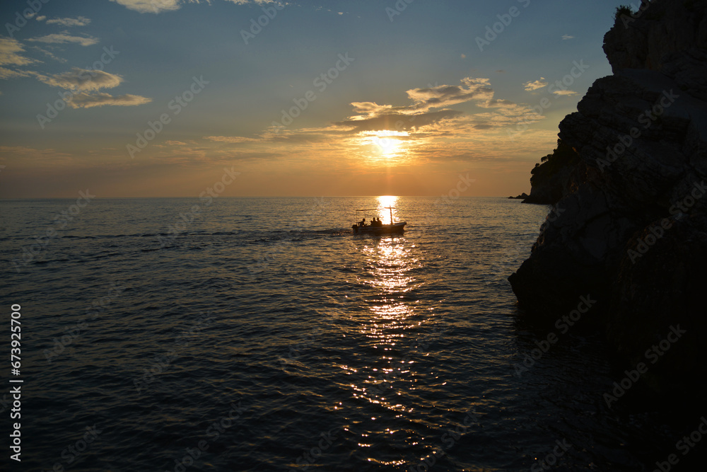 Silhouette of a boat at sunset over the sea