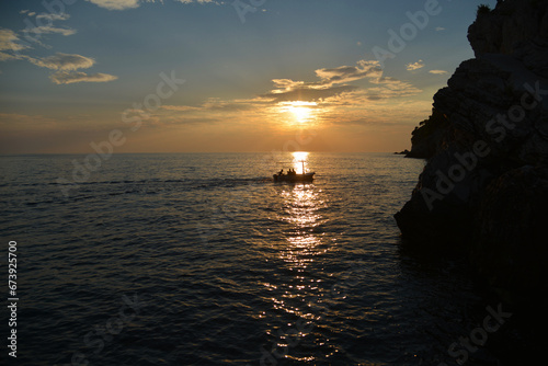 Silhouette of a boat at sunset over the sea