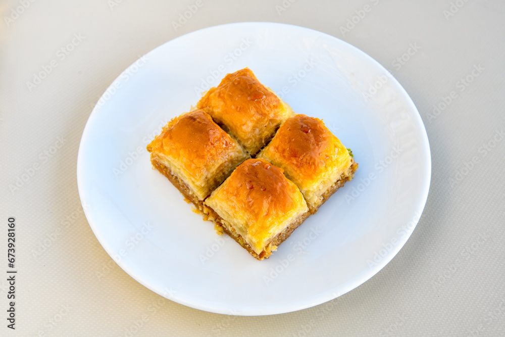 Turkish Dessert Sobiyet Baklava, kadayif, mussels baklava and classic baklava with Pistachio . Cevizli, Fistikli Baklava, top view. Turkish Dessert Sobiyet Baklava, kadayif, mussels baklava and classic baklava with Pistachio . Cevizli, Fistikli Baklava, top view.