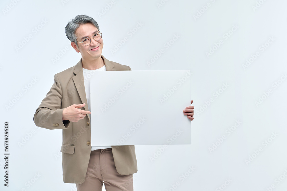 A middle-aged man in a suit and glasses is holding a white sign and making various facial expressions and gestures. A middle-aged man in a suit and glasses is holding a white sign and making various facial expressions and gestures.